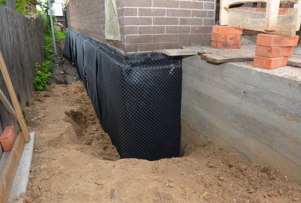 SJ Waterproofing Pros technician performing targeted Wet Basement Repair assessment in Lincoln, AL